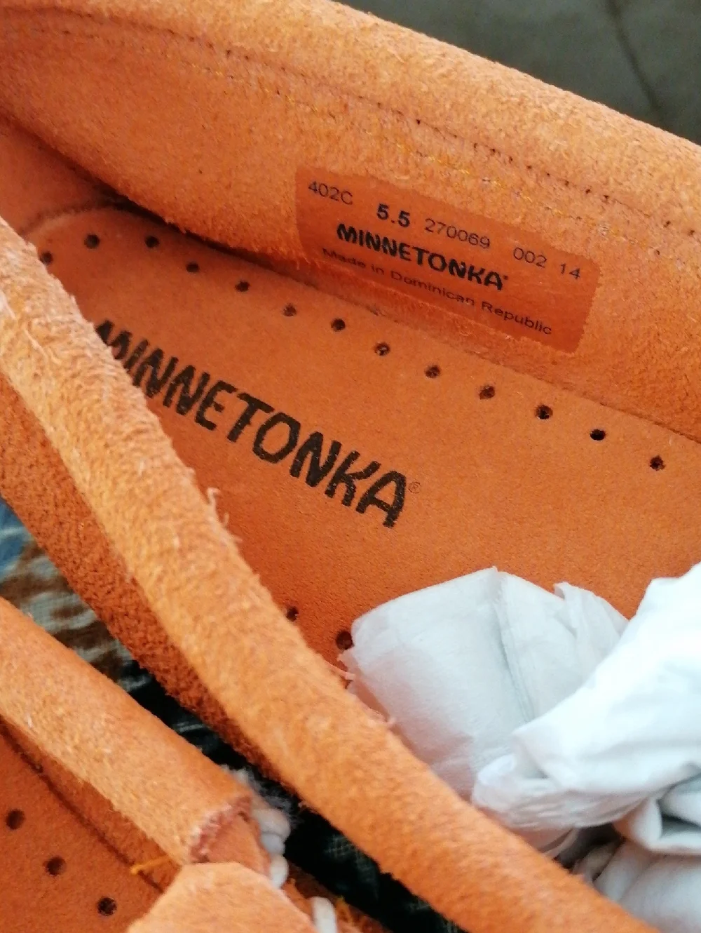 Minnetonka  Orange soft suede hard sole Moccasin.Never worn. Runs  big 5.5 = 6.5